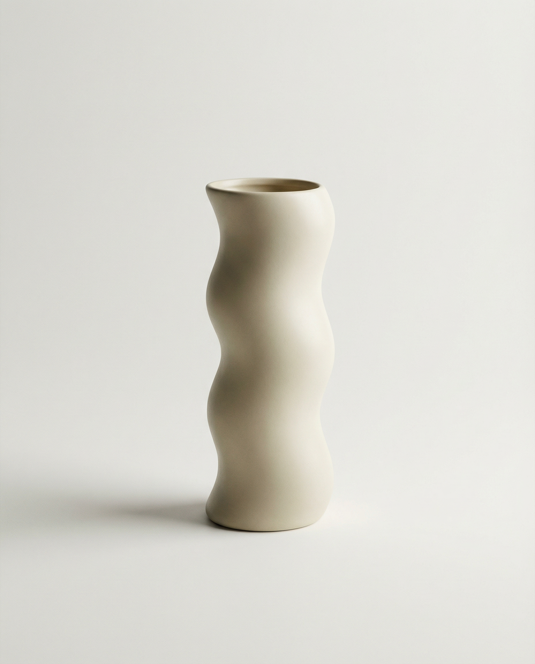 Ceramic vase with wavy design on a light gray background